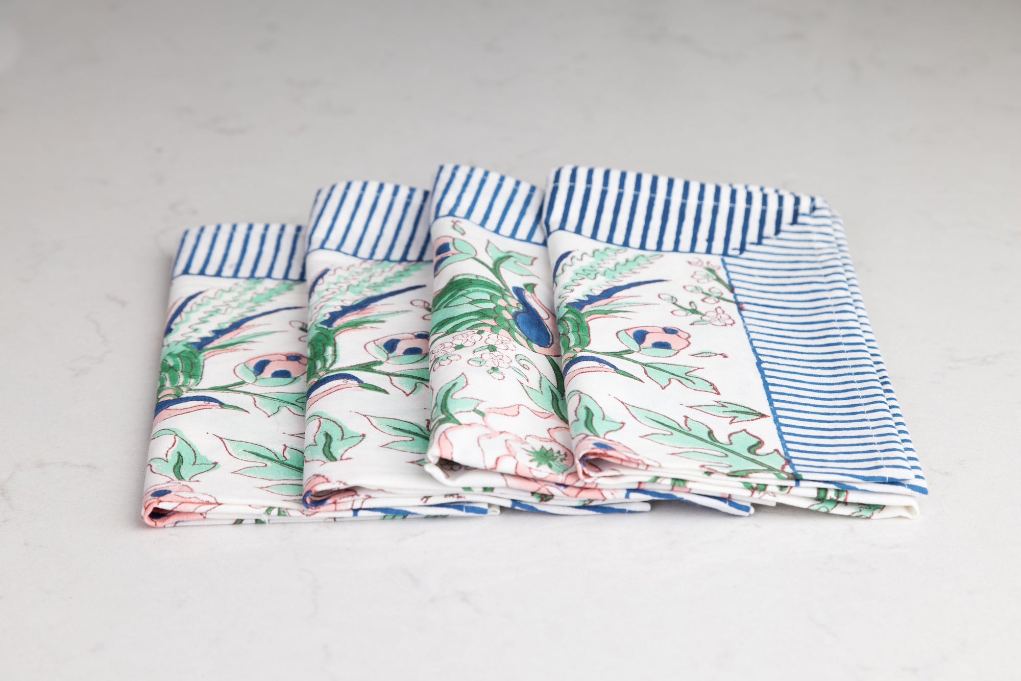 set of four pink, green and blue napkins